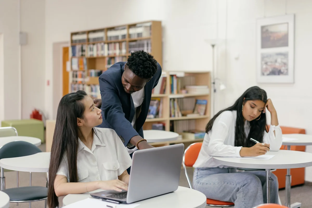 A teacher provides one-on-one guidance to a student using a laptop Mikhail Nilov  Pexels 5