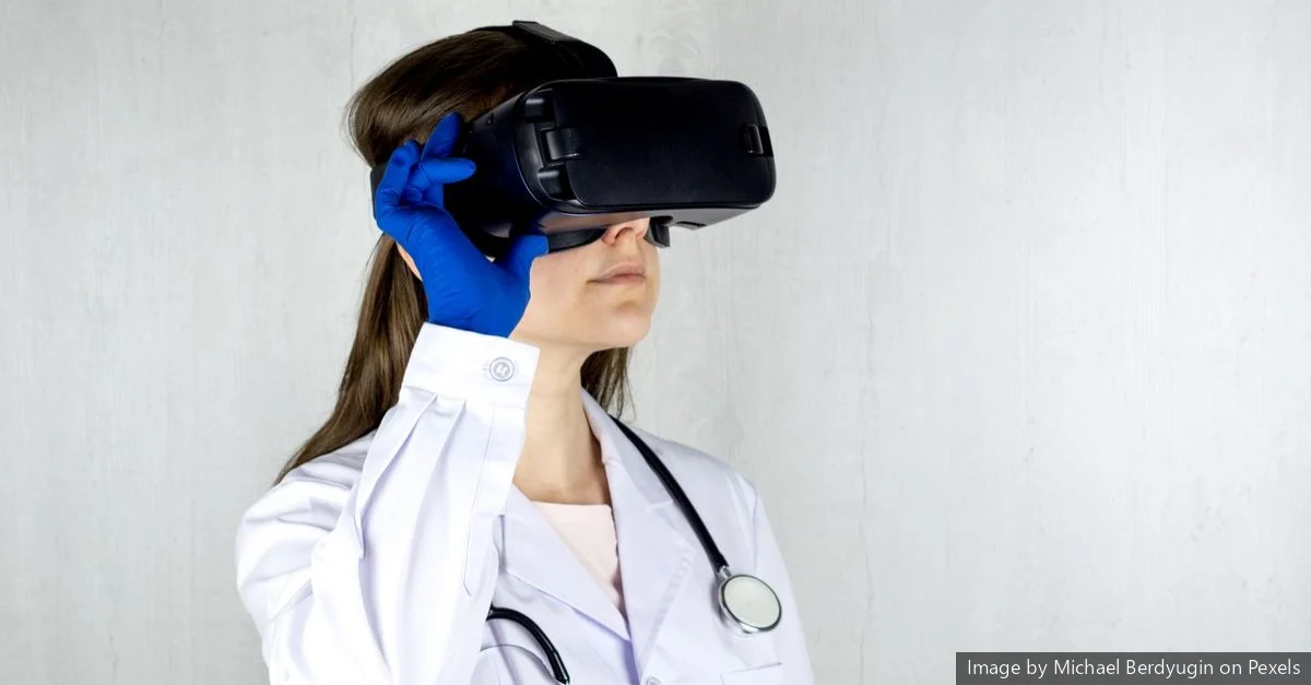 a Clinician in a White Coat and Gloves Wears a Vr Headset and Touches the Side of It A clinician in a white coat and gloves wears a VR headset and touches the side of it