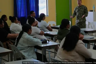 Instructor speaks to seated healthcare workers in a classroom