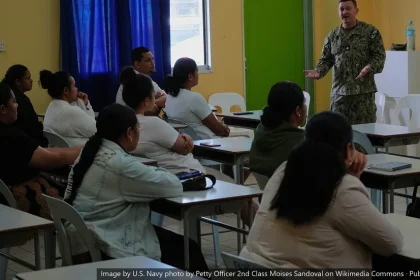 Instructor speaks to seated healthcare workers in a classroom